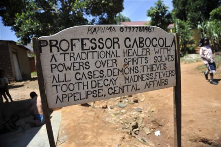 In this Feb. 10, 2010 photo, a sign stands outside the house of Musa Nsimbe who goes by the trade name Professor Gabogola, in Kampala, Uganda. (AP Photo/Riccardo Gangale)